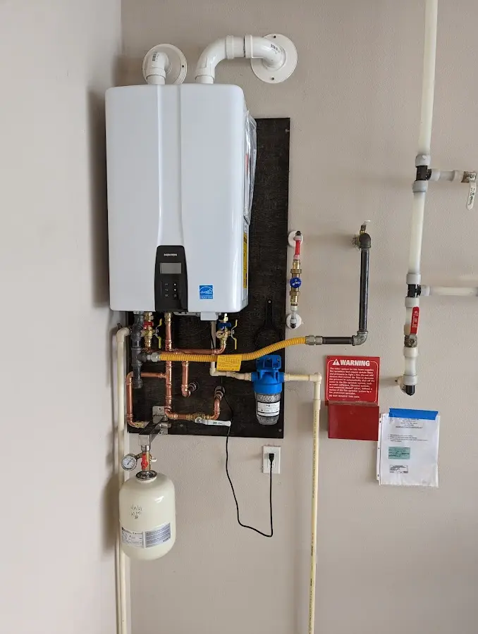 Professional plumber installing copper piping in a Lantana home